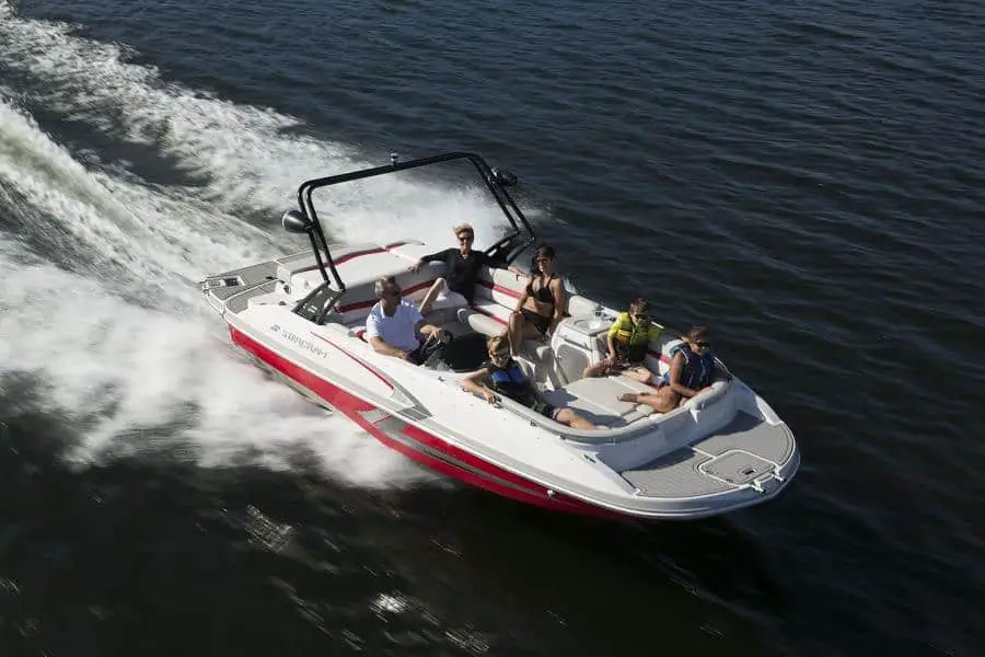 White and red boat with a broad forward seating area.
